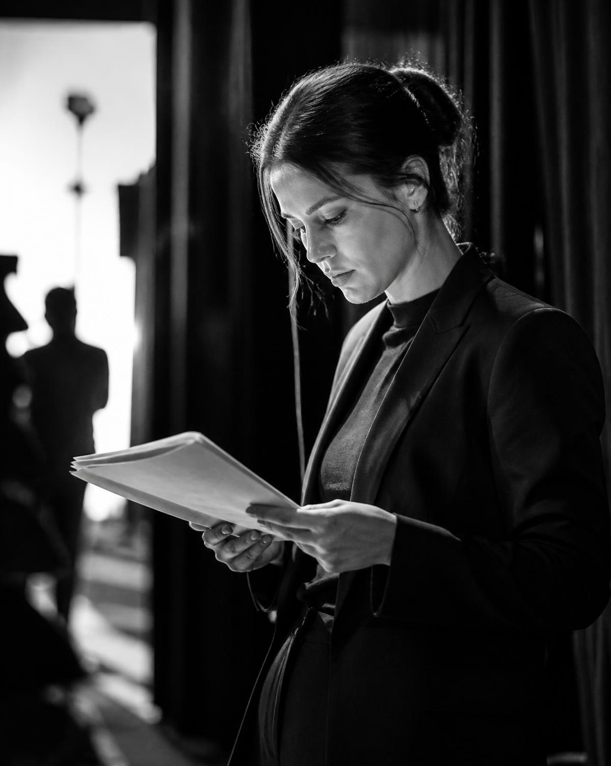 A professional reviewing notes before walking into a presentation